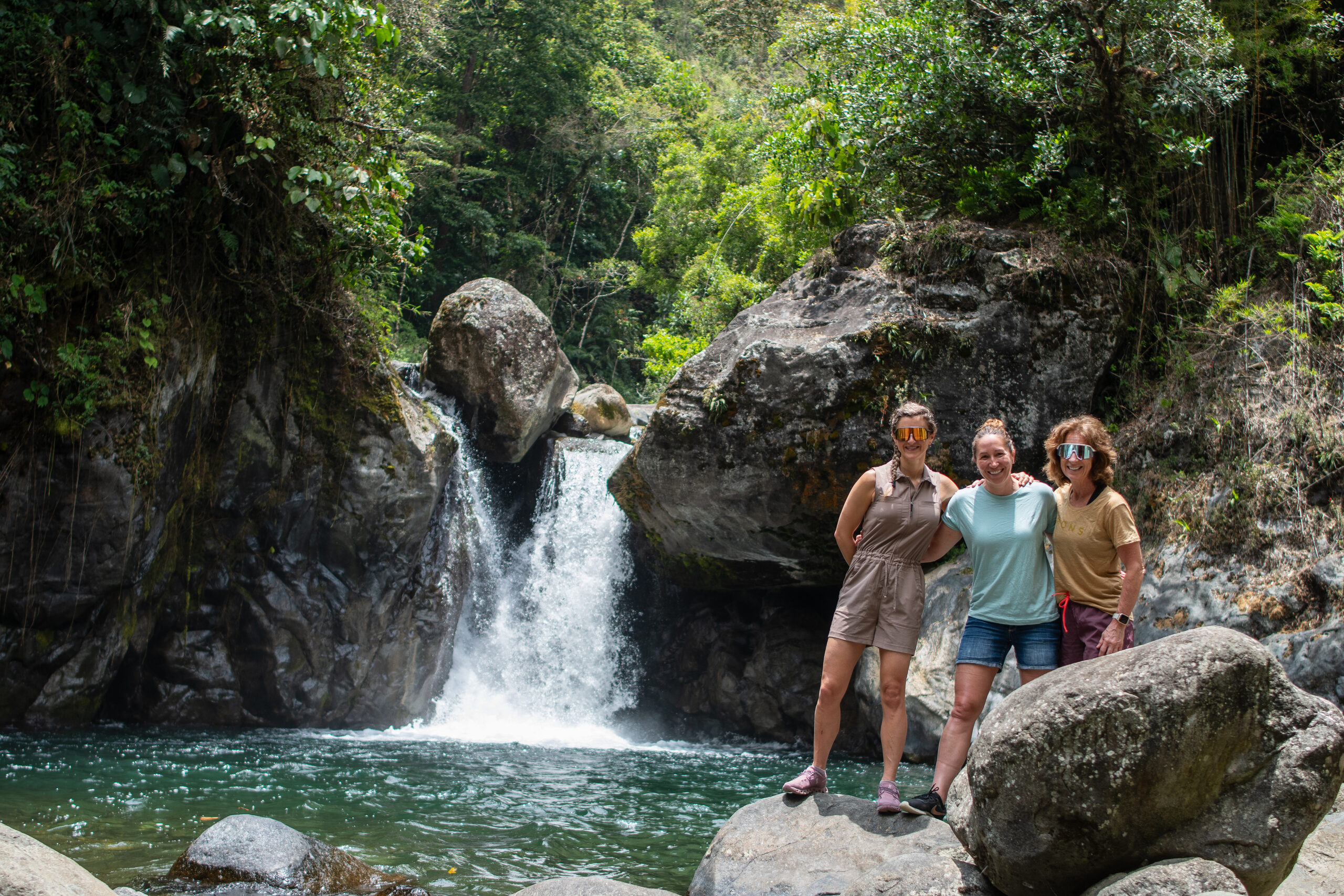 The group at a jungle waterfall